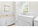 Laundry room with washer, dryer, sink, and storage space at 2143 Ridge Rd, Raleigh, NC 27607