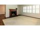 Cozy living room with a fireplace, plantation shutters, and classic trim at 2143 Ridge Rd, Raleigh, NC 27607