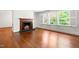Bright living room featuring hardwood floors, a fireplace and plenty of natural light from the large windows at 2143 Ridge Rd, Raleigh, NC 27607