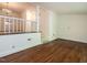 Living room with hardwood floors and stairs leading to an adjacent space at 2143 Ridge Rd, Raleigh, NC 27607