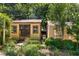 A view of backyard sheds surrounded by greenery, showcasing functional outdoor storage with a rustic appeal at 2143 Ridge Rd, Raleigh, NC 27607