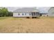 Exterior view of the back of the home showcasing a porch and newly seeded backyard at 24 Sanders Farm Dr, Smithfield, NC 27577