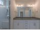 Bright bathroom boasts double vanity with granite countertop and tiled glass enclosed shower at 24 Sanders Farm Dr, Smithfield, NC 27577