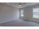 Well-lit bedroom with carpet, ceiling fan, and view from two bright windows at 24 Sanders Farm Dr, Smithfield, NC 27577