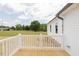 Exterior back porch featuring natural wood floor and white railings at 24 Sanders Farm Dr, Smithfield, NC 27577