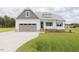 Charming single Gathering home with a 2-car garage, white siding, a covered porch and green grass at 24 Sanders Farm Dr, Smithfield, NC 27577