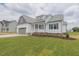 Beautiful single Gathering home with a 2-car garage, white siding, a covered porch and green grass at 24 Sanders Farm Dr, Smithfield, NC 27577