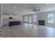 Spacious living room featuring wood floors, a ceiling fan, fireplace, and an open floor plan at 24 Sanders Farm Dr, Smithfield, NC 27577