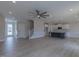 Open floor plan with a ceiling fan, wood floors, a fireplace, and a kitchen with an island at 24 Sanders Farm Dr, Smithfield, NC 27577