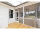 Back porch showcasing natural wood floor, white railings and a ceiling fan at 24 Sanders Farm Dr, Smithfield, NC 27577