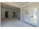 Spacious living room featuring an open layout with access to the outside and unfinished walls at 25 Sanders Farm Dr, Smithfield, NC 27577