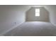 Well-lit attic room with a window, ready to be transformed into a functional living space at 25 Sanders Farm Dr, Smithfield, NC 27577