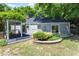 Spacious backyard with covered patio and landscaped flower bed at 2823 Fowler Ave, Raleigh, NC 27607