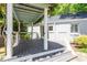 Covered back patio area with steps down to the backyard and access to the main building at 2823 Fowler Ave, Raleigh, NC 27607