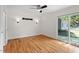 Bright bedroom with hardwood floors, ceiling fan, and access to the backyard at 2823 Fowler Ave, Raleigh, NC 27607