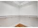 Empty walk-in closet with shelving and hardwood floors at 2823 Fowler Ave, Raleigh, NC 27607