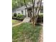 Charming home featuring a landscaped front yard with vibrant greenery and a quaint, inviting entryway at 2823 Fowler Ave, Raleigh, NC 27607