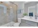 Bright bathroom with walk-in shower, modern vanity, and stylish mirror reflecting the room's decor at 2848 Angelica Rose Way, Apex, NC 27502