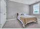 Neutral bedroom with a bed, light colored carpet, and natural light from the window at 2848 Angelica Rose Way, Apex, NC 27502