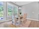 Bright dining area features a modern table with seating for four and natural light at 2848 Angelica Rose Way, Apex, NC 27502