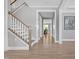 Inviting entryway with hardwood floors, staircase, and views into the living spaces at 2848 Angelica Rose Way, Apex, NC 27502