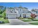 Charming two-story home featuring a two-car garage and well-manicured front lawn at 2848 Angelica Rose Way, Apex, NC 27502