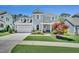 Two-story home with gray siding, dormer windows, a two-car garage, landscaped yard, and sidewalk at 2848 Angelica Rose Way, Apex, NC 27502