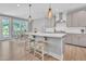 Kitchen island with seating connects the kitchen and dining areas in an open-concept design at 2848 Angelica Rose Way, Apex, NC 27502