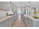 Modern kitchen features light gray cabinets, stainless steel appliances, and a spacious island for cooking and entertaining at 2848 Angelica Rose Way, Apex, NC 27502
