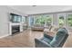 Inviting living room features a fireplace, large windows, and neutral color palette throughout at 2848 Angelica Rose Way, Apex, NC 27502