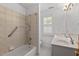 Well-lit bathroom featuring a shower-tub combo and a double-sink vanity at 30119 Settle, Chapel Hill, NC 27517