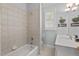 Bright bathroom featuring a tiled shower and tub combination with a stylish vanity area at 30119 Settle, Chapel Hill, NC 27517