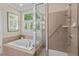Bathroom with a large soaking tub, shower and a large bright window at 30119 Settle, Chapel Hill, NC 27517