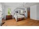Bedroom with hardwood floors, four-poster bed, and lots of natural light at 30119 Settle, Chapel Hill, NC 27517