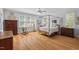 Spacious primary bedroom boasts hardwood floors, a canopy bed, and lots of natural light at 30119 Settle, Chapel Hill, NC 27517