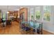 Bright open kitchen flows into a dining area featuring a clear glass table and stainless steel appliances at 30119 Settle, Chapel Hill, NC 27517