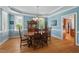 Elegant dining room with blue walls, hardwood floors, and a chandelier over a wooden table at 30119 Settle, Chapel Hill, NC 27517