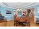 Elegant dining room with wood floors, a chandelier, and stylish blue-painted walls with white trim at 30119 Settle, Chapel Hill, NC 27517
