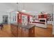 An open kitchen flows into the living room with an island and hardwood floors, creating a welcoming space at 30119 Settle, Chapel Hill, NC 27517