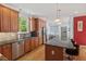 Well-equipped kitchen with wooden cabinetry, stainless steel appliances, and an island with bar seating at 30119 Settle, Chapel Hill, NC 27517
