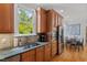 Bright kitchen featuring stainless steel appliances, wooden cabinets, and a view of the dining area through the window at 30119 Settle, Chapel Hill, NC 27517