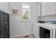 Well-lit laundry room with a side-by-side washer and dryer, and shuttered windows providing bright natural light at 30119 Settle, Chapel Hill, NC 27517