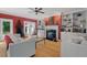 Cozy living room with a fireplace, built-in shelves, hardwood floors, and bright red accent wall at 30119 Settle, Chapel Hill, NC 27517