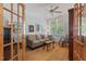 Cozy office with hardwood floors, French doors, and a comfortable seating area by the windows at 30119 Settle, Chapel Hill, NC 27517