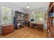 Bright office space with hardwood floors, built-in bookshelves, and large windows offering natural light at 30119 Settle, Chapel Hill, NC 27517
