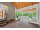Spacious screened-in porch with wood floors, white lattice railings, and a cozy seating area at 30119 Settle, Chapel Hill, NC 27517