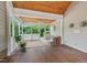 Inviting screened-in porch with wood floors, white lattice railings, and serene views of the surrounding nature at 30119 Settle, Chapel Hill, NC 27517