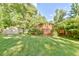 Expansive backyard boasts a wooden deck with privacy lattice and ample green space for activities at 308 Rainbow Dr, Carrboro, NC 27510