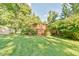 Lush backyard features a wooden deck with privacy lattice, perfect for outdoor relaxation and entertaining at 308 Rainbow Dr, Carrboro, NC 27510