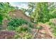 Scenic backyard featuring lush landscaping and a peaceful stone path at 308 Rainbow Dr, Carrboro, NC 27510